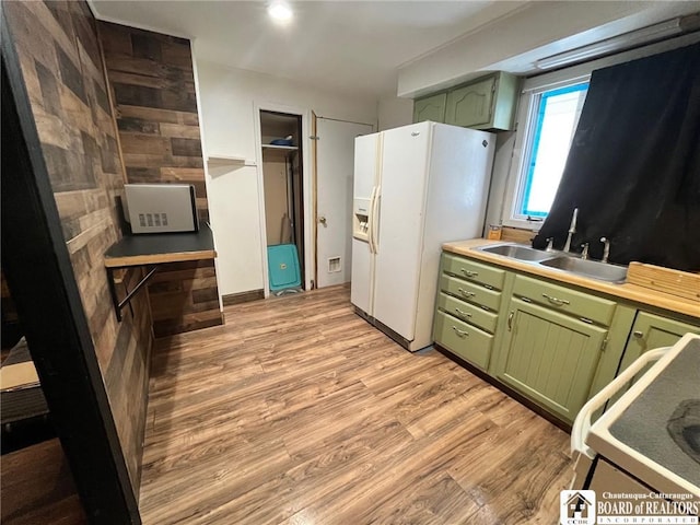 kitchen featuring light hardwood / wood-style floors, sink, white appliances, and green cabinetry