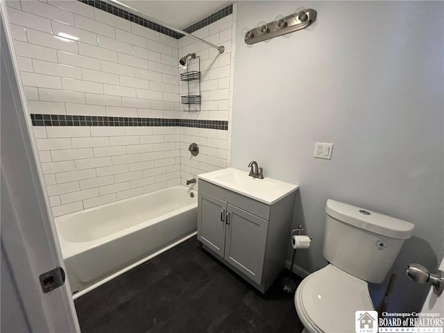 full bathroom featuring tiled shower / bath combo, vanity, and toilet