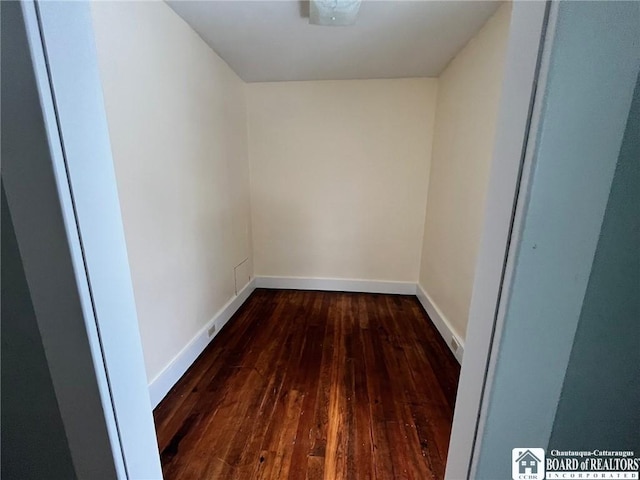 empty room with dark hardwood / wood-style flooring