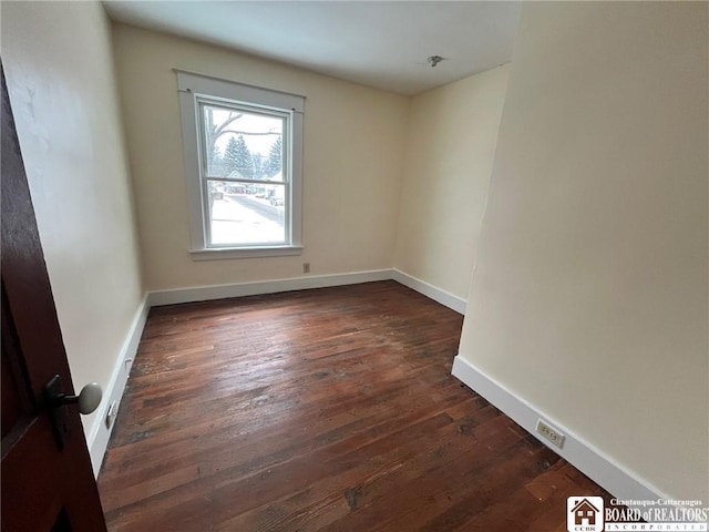 empty room with dark hardwood / wood-style floors