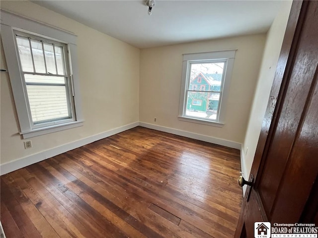 empty room with dark wood-type flooring