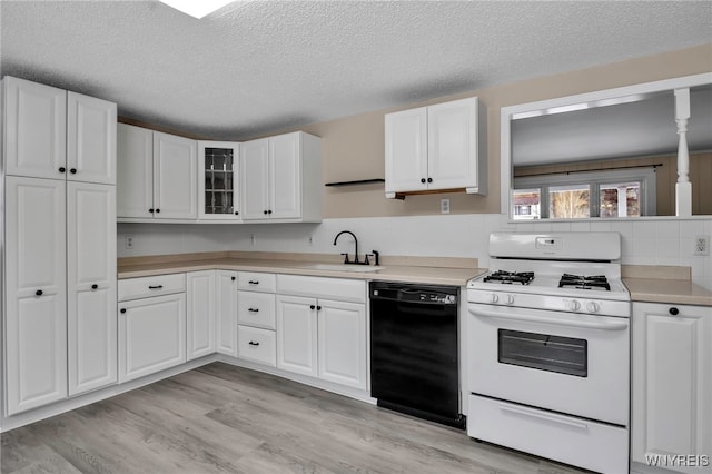 kitchen with sink, white range with gas stovetop, white cabinetry, light wood-type flooring, and dishwasher