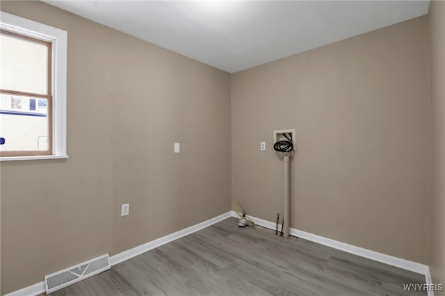 laundry room with washer hookup, hookup for a gas dryer, and wood-type flooring