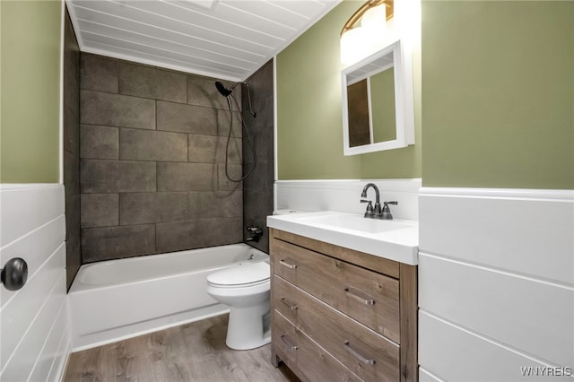 full bathroom with vanity, tiled shower / bath combo, wood-type flooring, and toilet