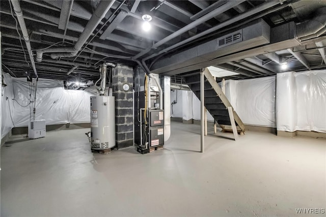 basement featuring water heater and heating unit