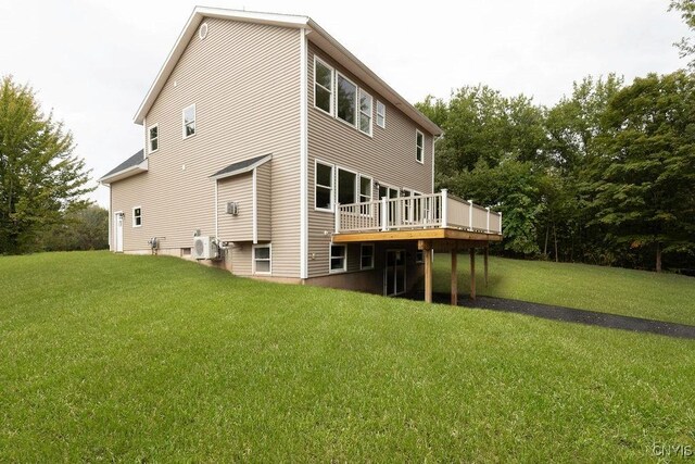 rear view of house with a yard and a deck