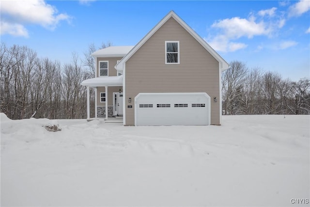 view of property with a garage and a porch