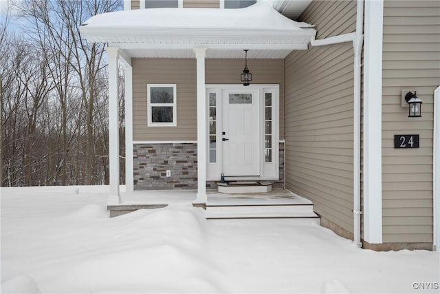 view of snow covered property entrance