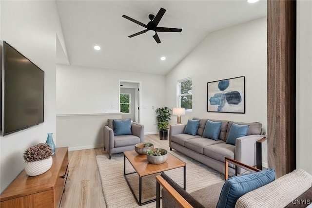 living room featuring high vaulted ceiling, ceiling fan, and light hardwood / wood-style flooring