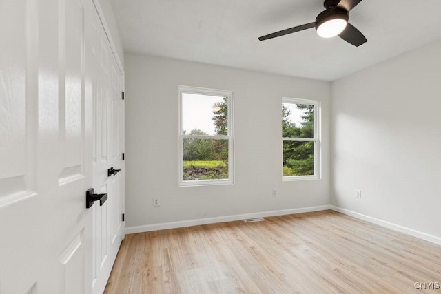 spare room with light hardwood / wood-style flooring and ceiling fan