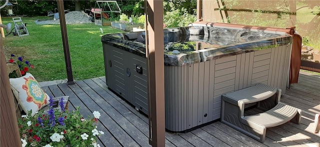 wooden deck with a yard and a hot tub