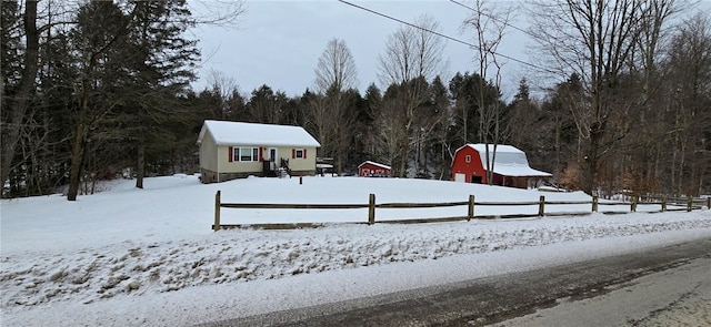 yard layered in snow featuring an outbuilding