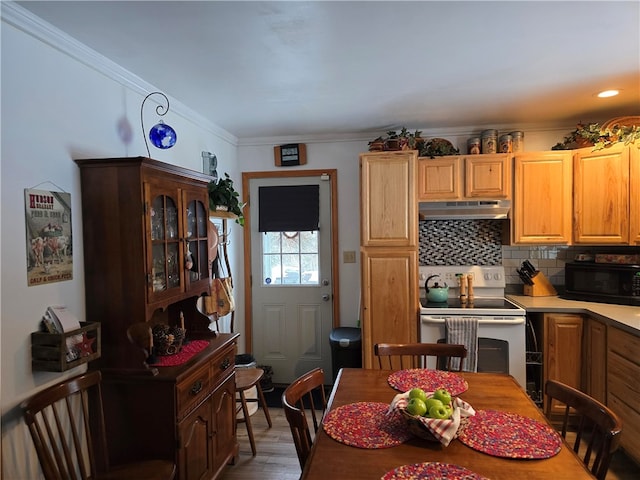 kitchen featuring backsplash, hardwood / wood-style flooring, ornamental molding, and white range with electric cooktop