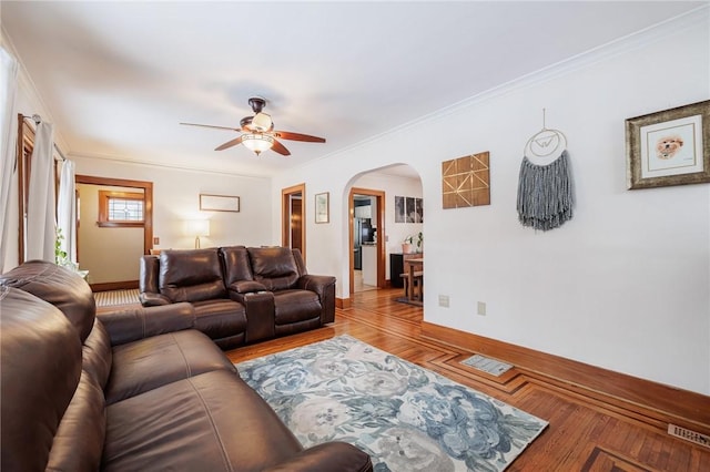 living room with crown molding, ceiling fan, and hardwood / wood-style floors