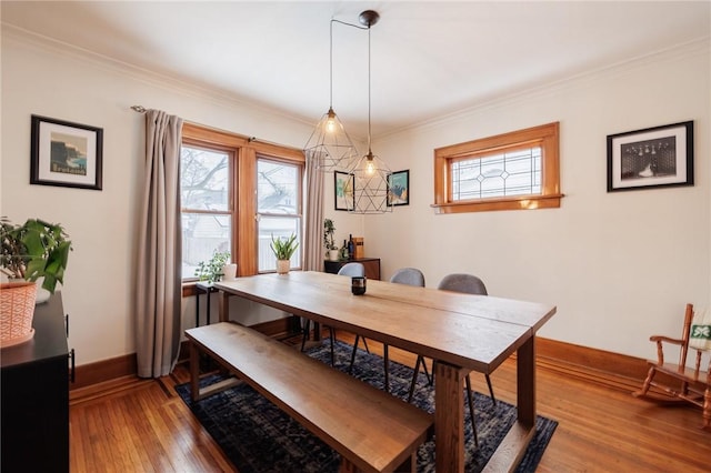 dining space featuring ornamental molding and wood-type flooring