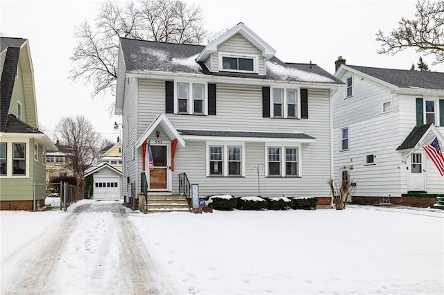 view of front of property featuring a garage and an outdoor structure