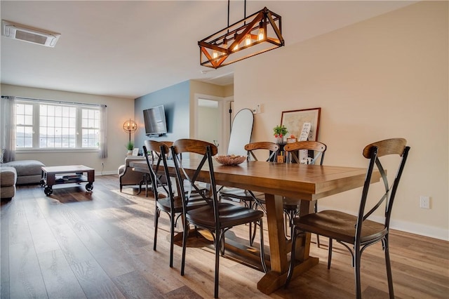 dining room featuring hardwood / wood-style floors and a notable chandelier