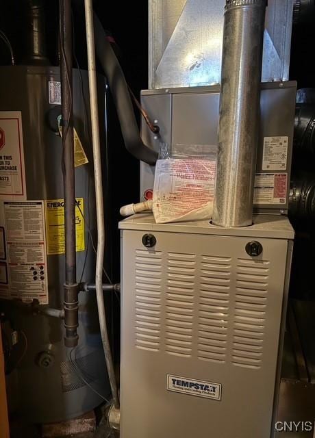 utility room with water heater and heating unit