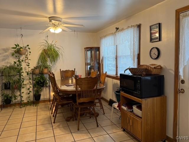 tiled dining space featuring ceiling fan