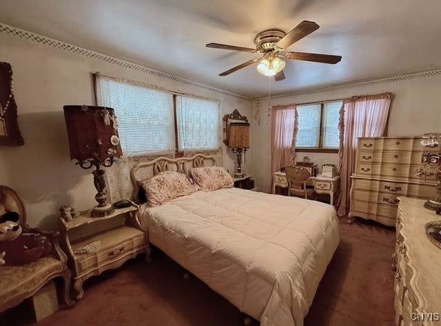 bedroom featuring dark carpet and ceiling fan