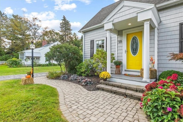 entrance to property featuring a yard