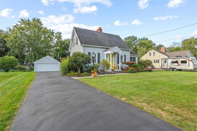 cape cod house featuring a garage, an outdoor structure, and a front yard