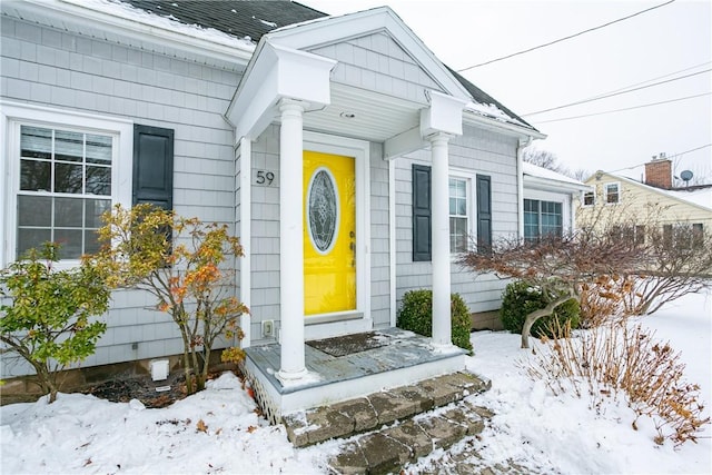 view of snow covered property entrance