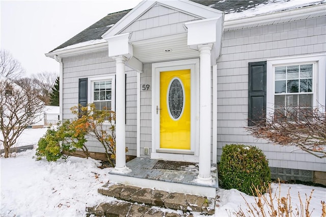 view of snow covered property entrance