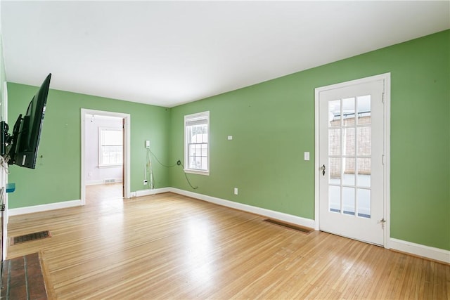 empty room with light hardwood / wood-style flooring