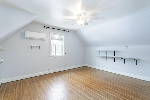 bonus room with hardwood / wood-style floors, vaulted ceiling, a wall unit AC, and ceiling fan