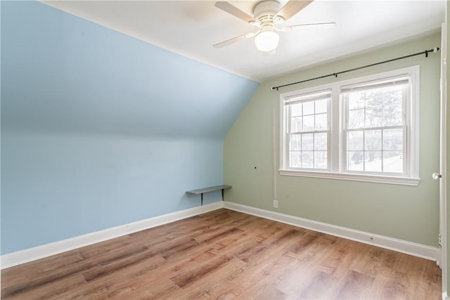 additional living space featuring lofted ceiling, light hardwood / wood-style flooring, and ceiling fan