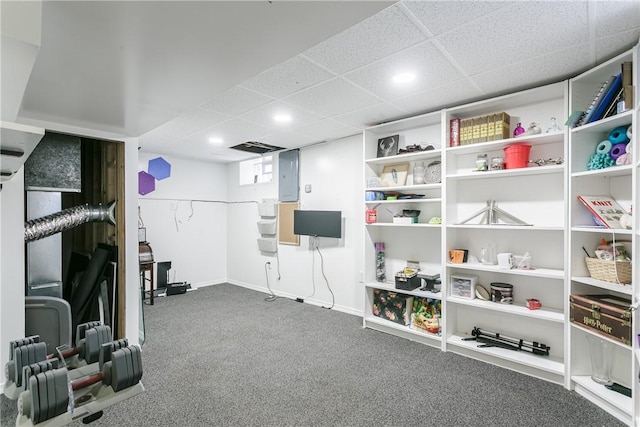 workout room featuring carpet and a drop ceiling