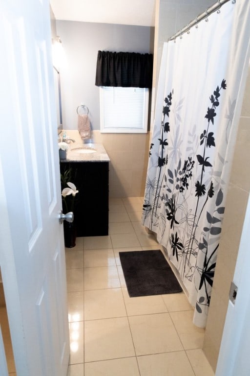 bathroom with vanity, a shower with curtain, and tile patterned floors