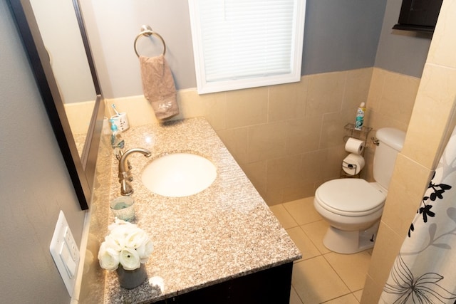 bathroom featuring tile walls, vanity, tile patterned floors, and toilet