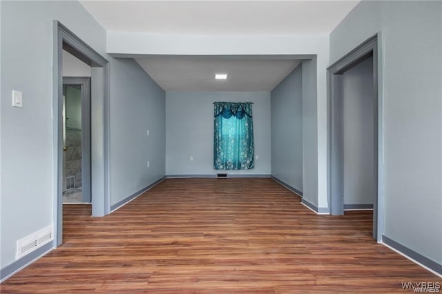 spare room with wood-type flooring