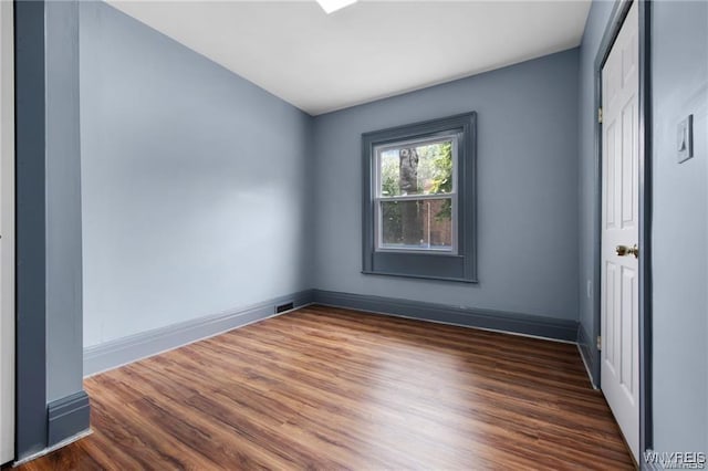 unfurnished room featuring dark hardwood / wood-style flooring