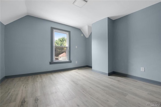 bonus room with vaulted ceiling and light hardwood / wood-style floors