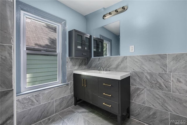 bathroom with vanity and tile walls