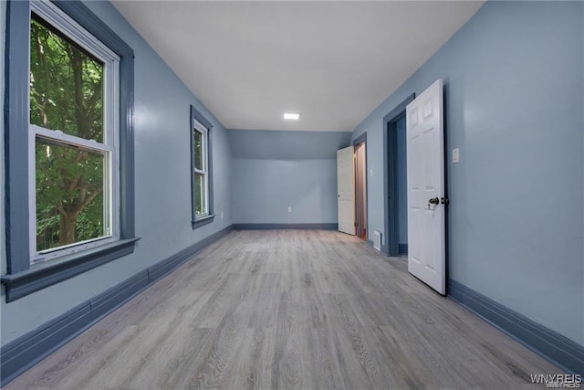 empty room with light hardwood / wood-style floors