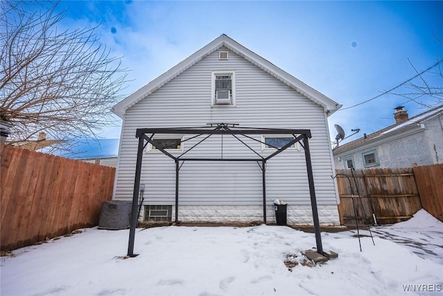 view of snow covered rear of property