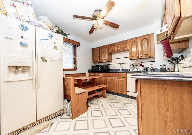 kitchen featuring tasteful backsplash, sink, white appliances, and ceiling fan