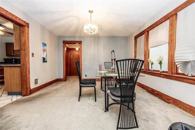 dining room featuring a notable chandelier and light colored carpet