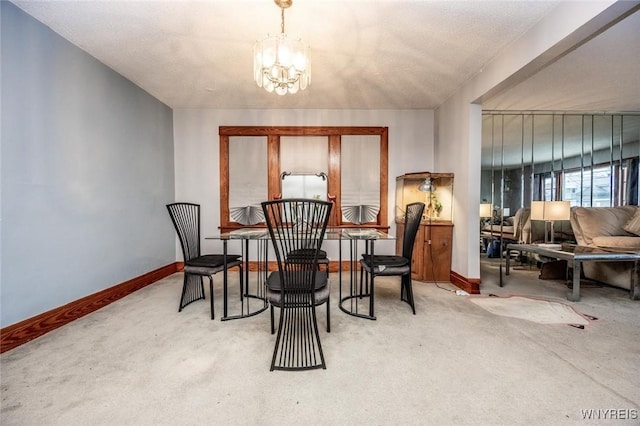 dining space with a chandelier and carpet floors