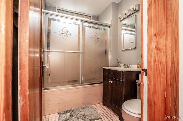 full bathroom featuring toilet, vanity, bath / shower combo with glass door, and tile patterned flooring