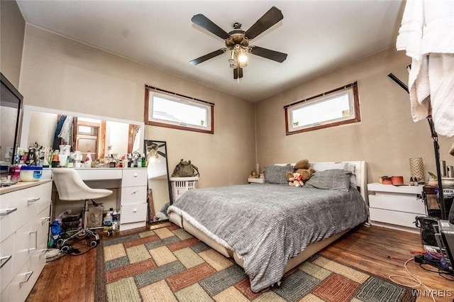 bedroom with ceiling fan and dark hardwood / wood-style floors