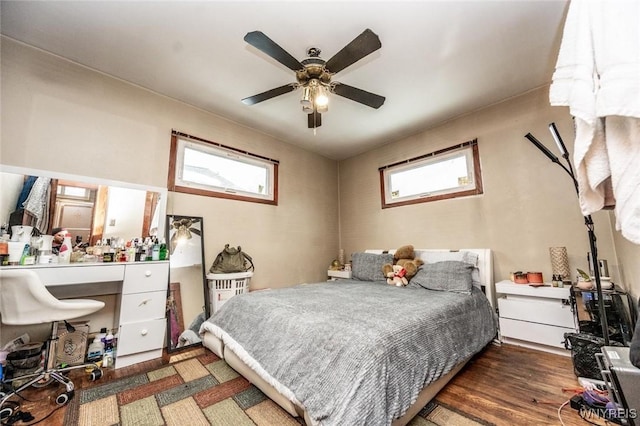 bedroom with dark wood-type flooring and ceiling fan