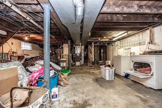 basement featuring washer / dryer and heating unit