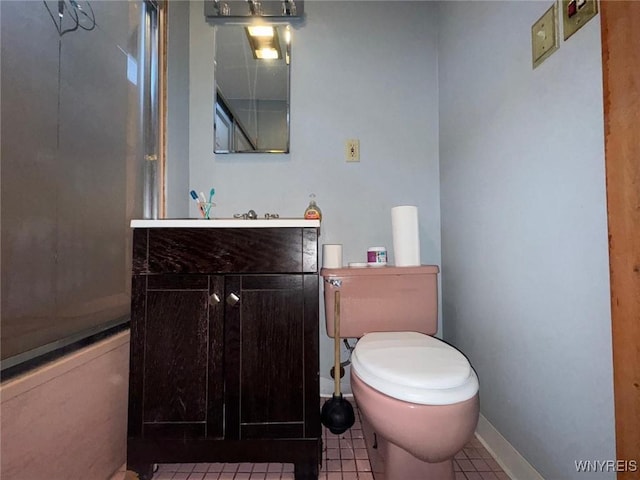 bathroom with tile patterned floors, toilet, a shower with shower door, and vanity