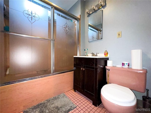 full bathroom featuring vanity, bath / shower combo with glass door, tile patterned floors, and toilet