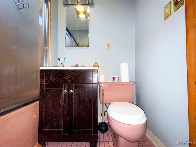 bathroom with vanity, toilet, and tile patterned flooring